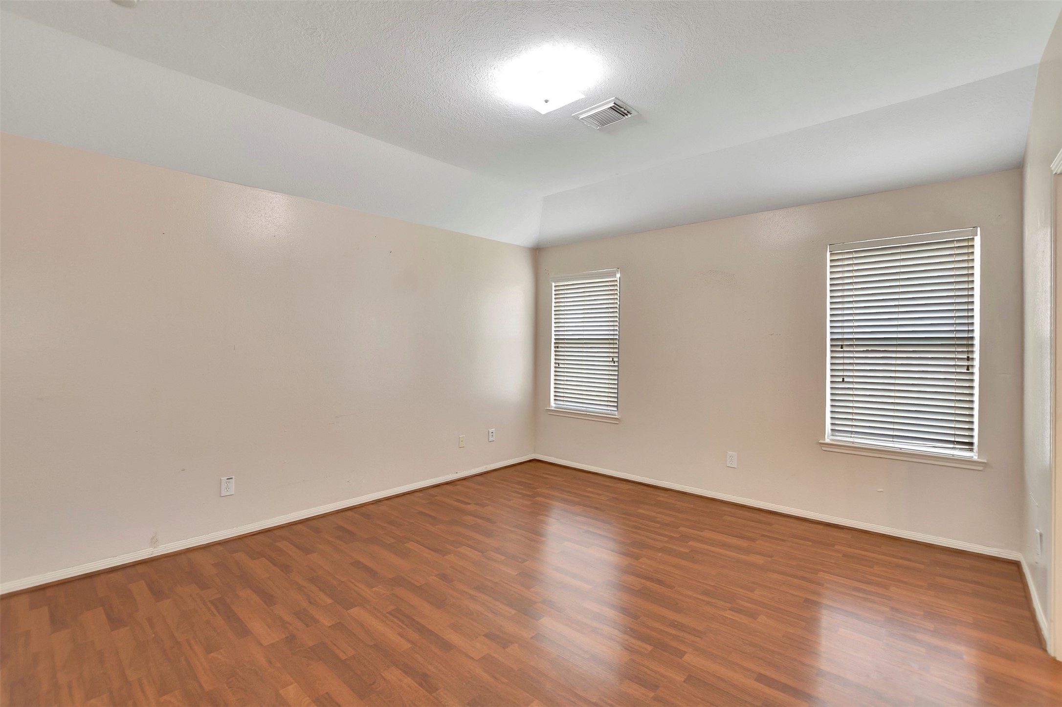 5918 Durango Mist Lane Katy, TX 77449 - Photo 32 of 41 an empty room with wooden floor and windows