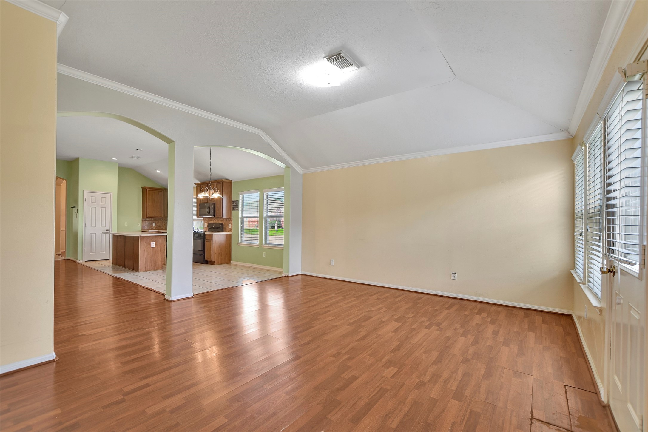 5918 Durango Mist Lane Katy, TX 77449 - Photo 6 of 41 a view of an empty room with wooden floor and a window