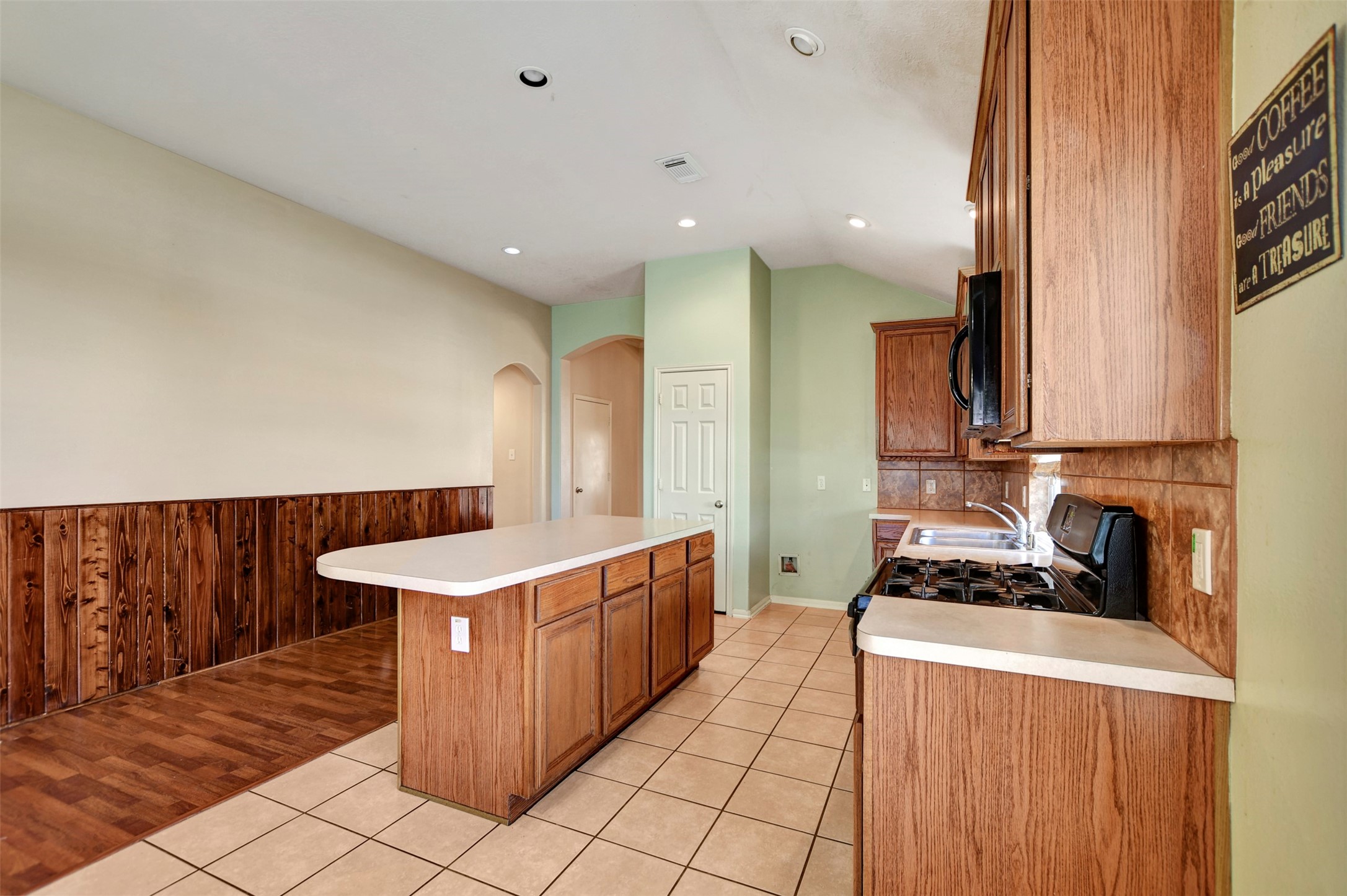 5918 Durango Mist Lane Katy, TX 77449 - Photo 7 of 41 a kitchen with a sink and a stove top oven