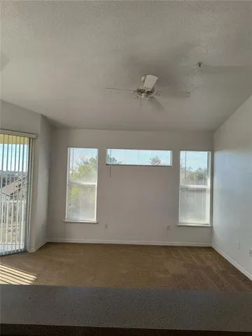 a view of an empty room and a window