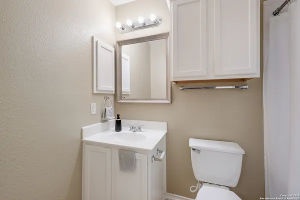 a bathroom with a sink a toilet and vanity
