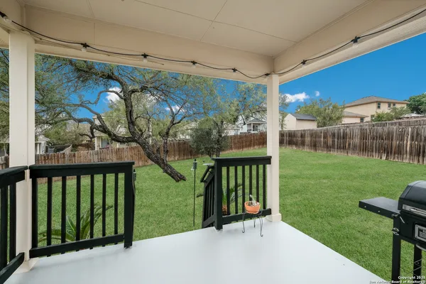 a view of a backyard with a garden and entertaining space