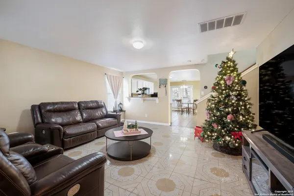 a living room with furniture and a christmas tree