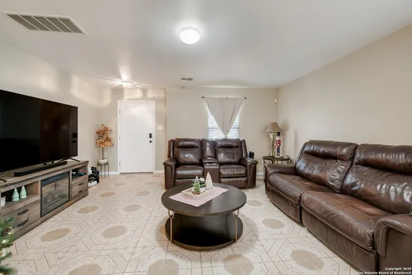 a living room with furniture and a flat screen tv