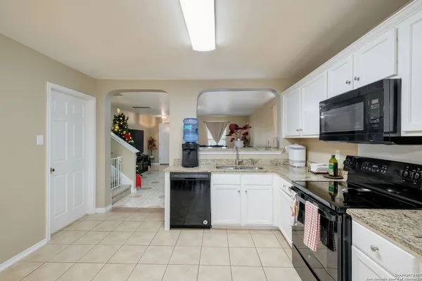 a kitchen with stainless steel appliances granite countertop a sink and a stove