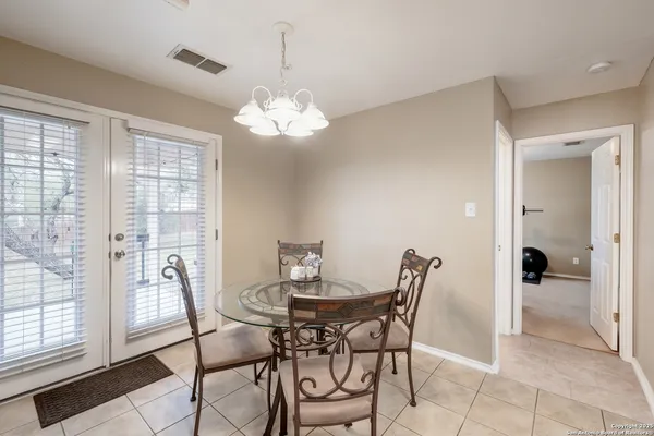 a view of a dining room with furniture and chandelier