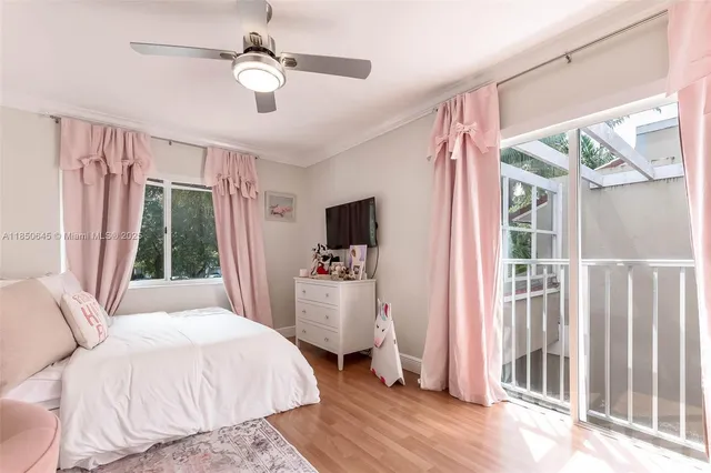 a bedroom with a bed and a flat tv screen