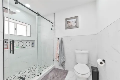 a white toilet sitting next to a bathroom sink