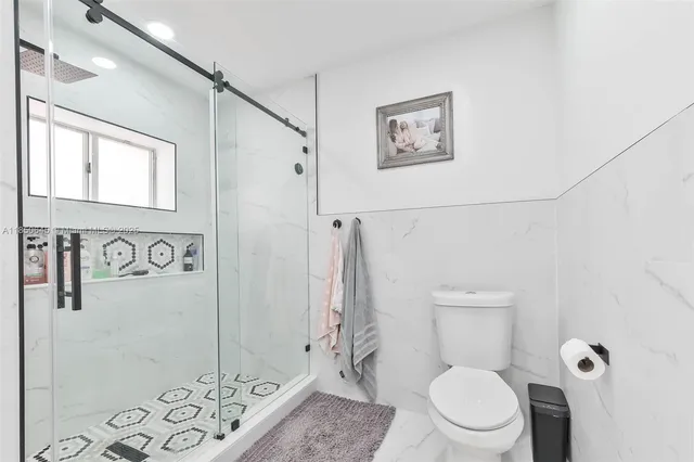 a white toilet sitting next to a bathroom sink