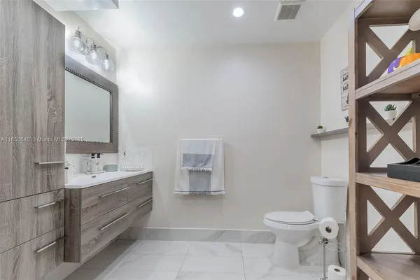 a bathroom with a toilet sink and mirror