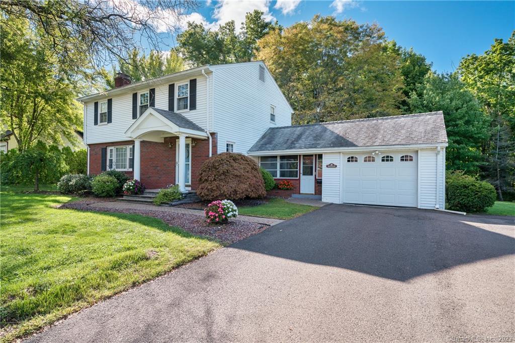 31 Timber Hill Road Cromwell, CT 06416 - Photo 1 of 1 a front view of a house with a yard and garage