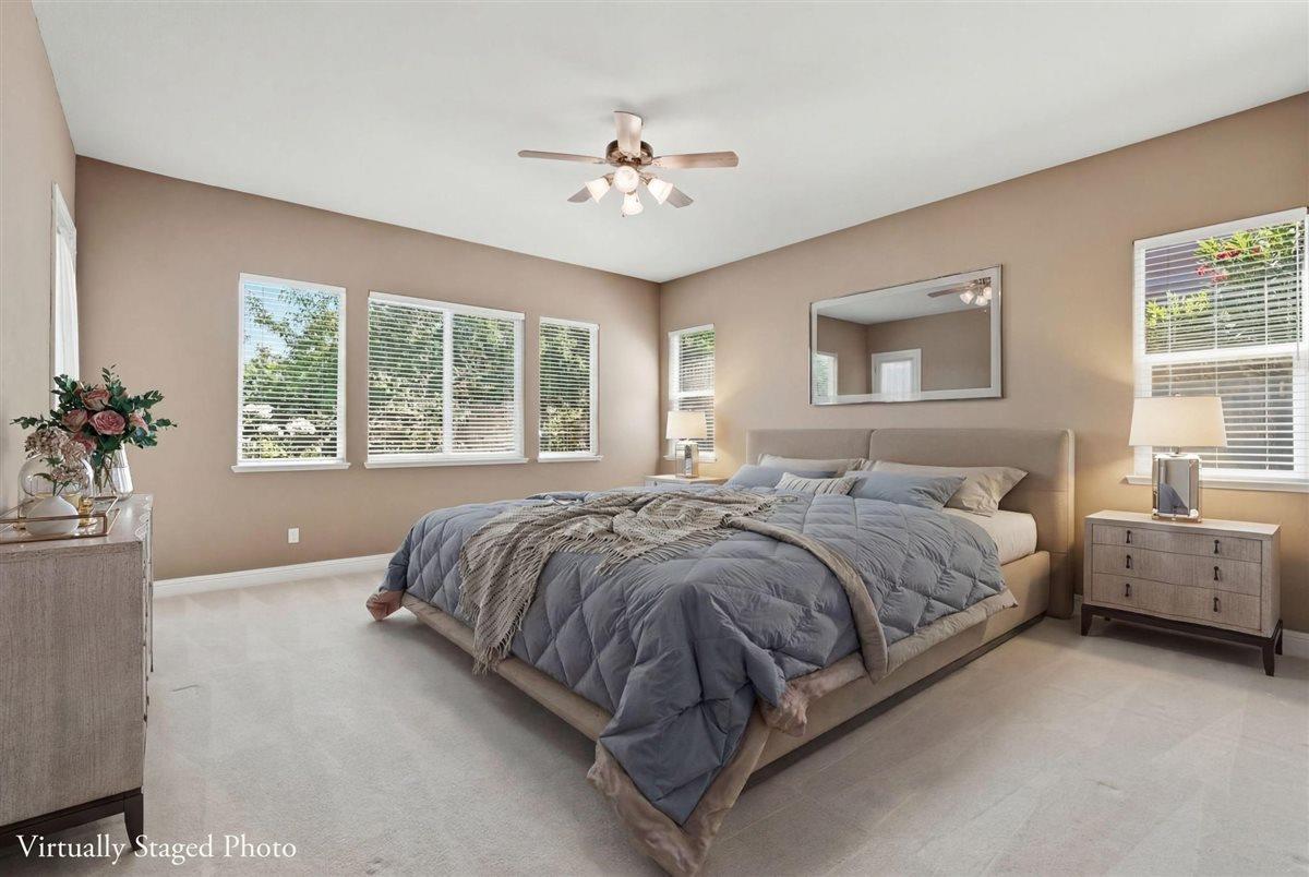 4129 Poppleton Way Carmichael, CA 95608 - Photo 28 of 48 a spacious bedroom with a large bed and a chandelier
