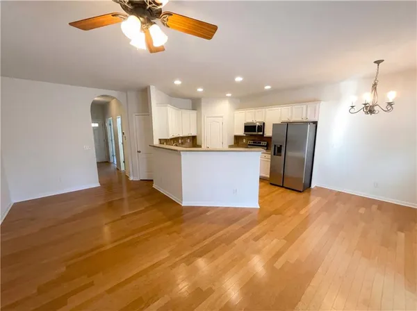 a view of a kitchen with a stove cabinets and wooden floor