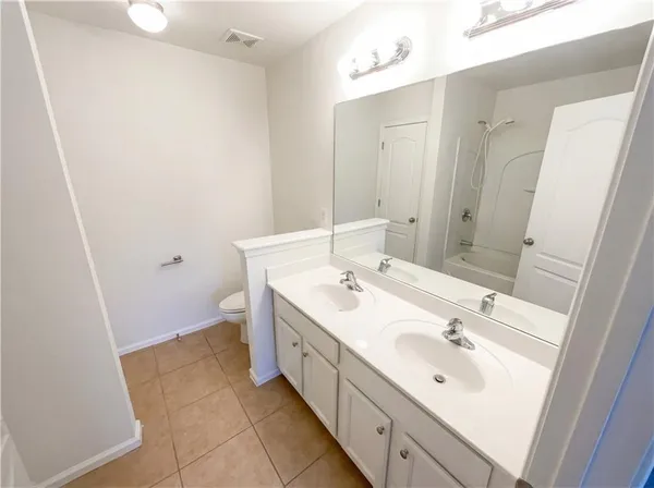 a bathroom with a tub and shower