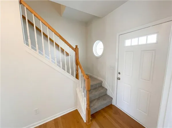 a view of an entryway with wooden floor