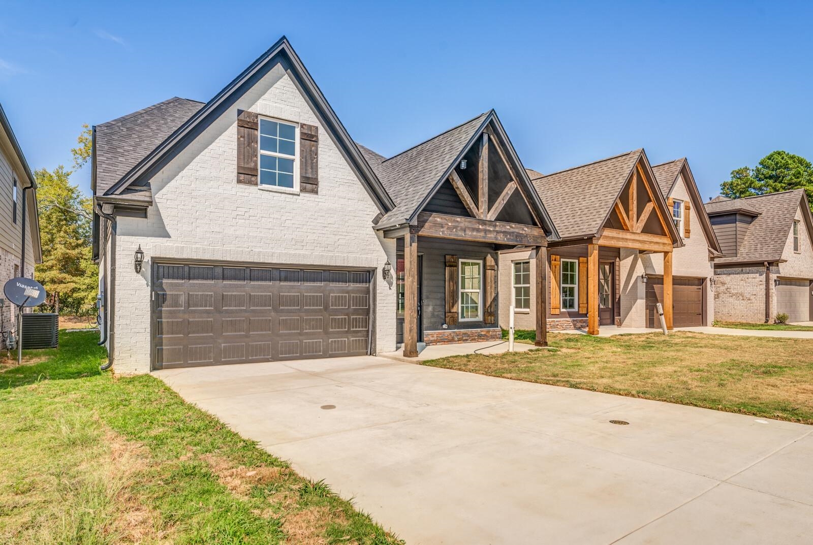 60 Umble Street Oakland, TN 38060 - Photo 2 of 40 a front view of a house with a yard and garage