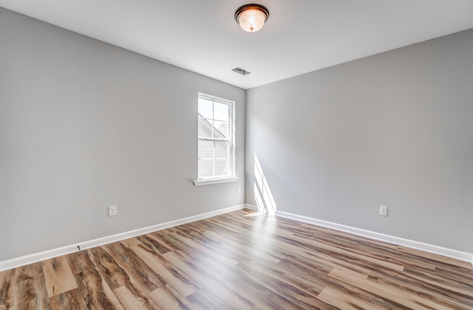 60 Umble Street Oakland, TN 38060 - Photo 26 of 40 an empty room with wooden floor and windows
