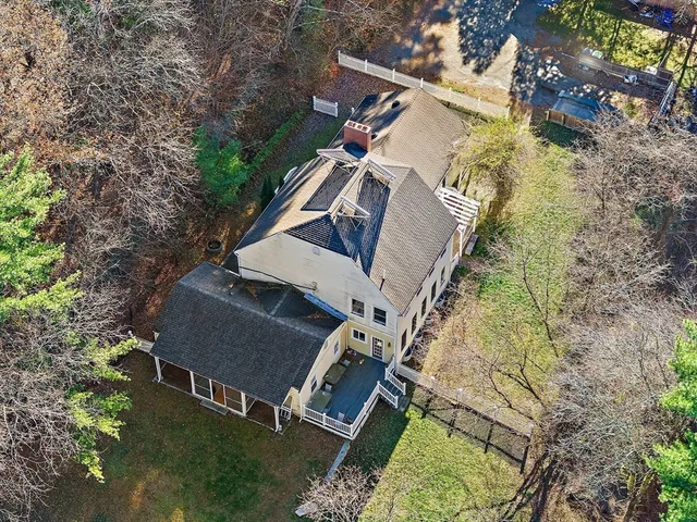 an aerial view of a house with a yard