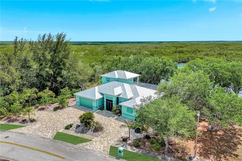 a view of a garden with a table and chairs under an umbrella