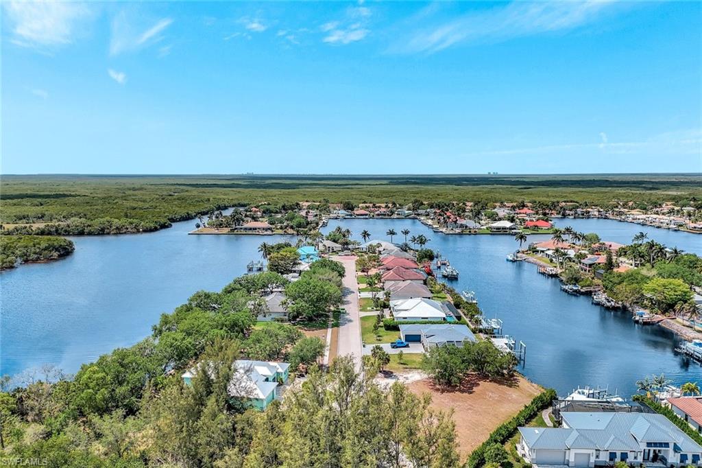 144 Wilderness Cay Naples, FL 34114 - Photo 13 of 42 an aerial view of residential building and lake