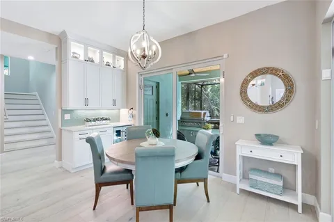 a view of a dining room with furniture and chandelier