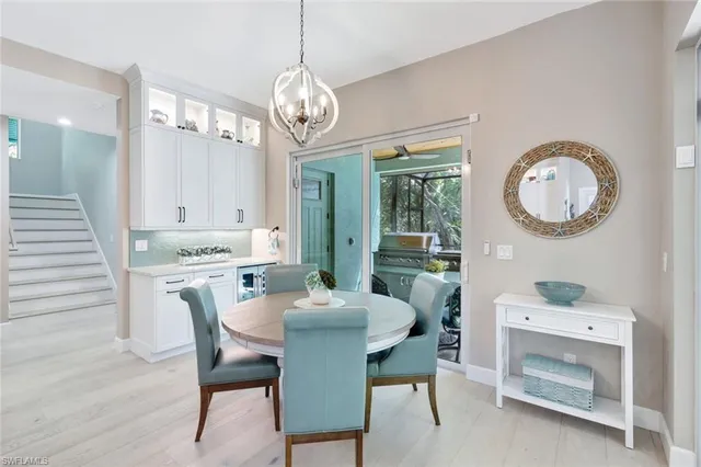 a view of a dining room with furniture and chandelier