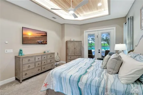 a bedroom with a bed a window and dresser