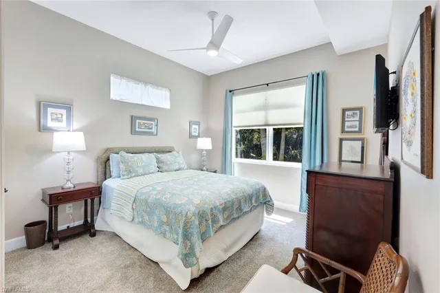 a bedroom with a bed chair and window