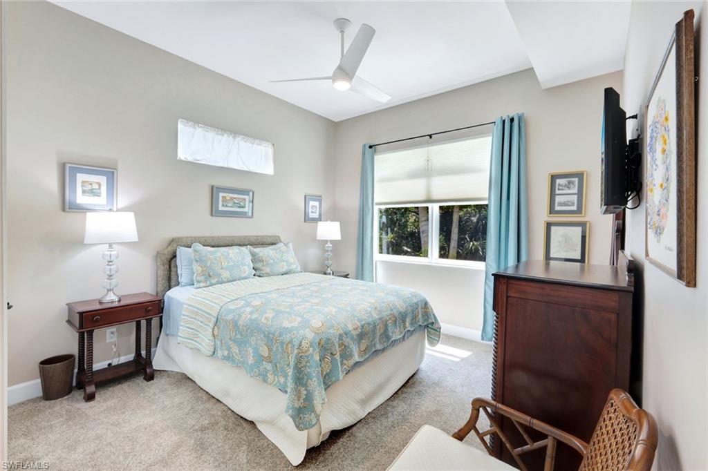 144 Wilderness Cay Naples, FL 34114 - Photo 21 of 42 a bedroom with a bed chair and window
