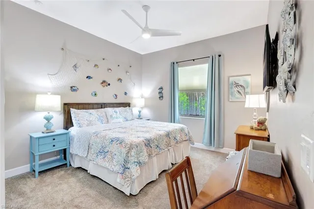 a bedroom with a bed and a flat tv screen on dresser