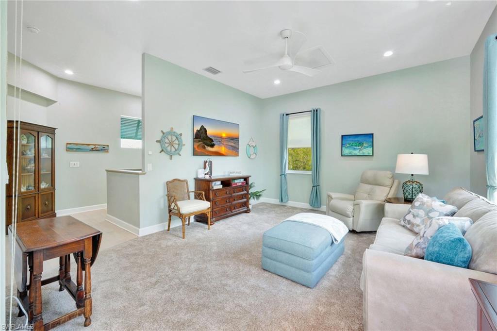 144 Wilderness Cay Naples, FL 34114 - Photo 26 of 42 a living room with furniture and a flat screen tv