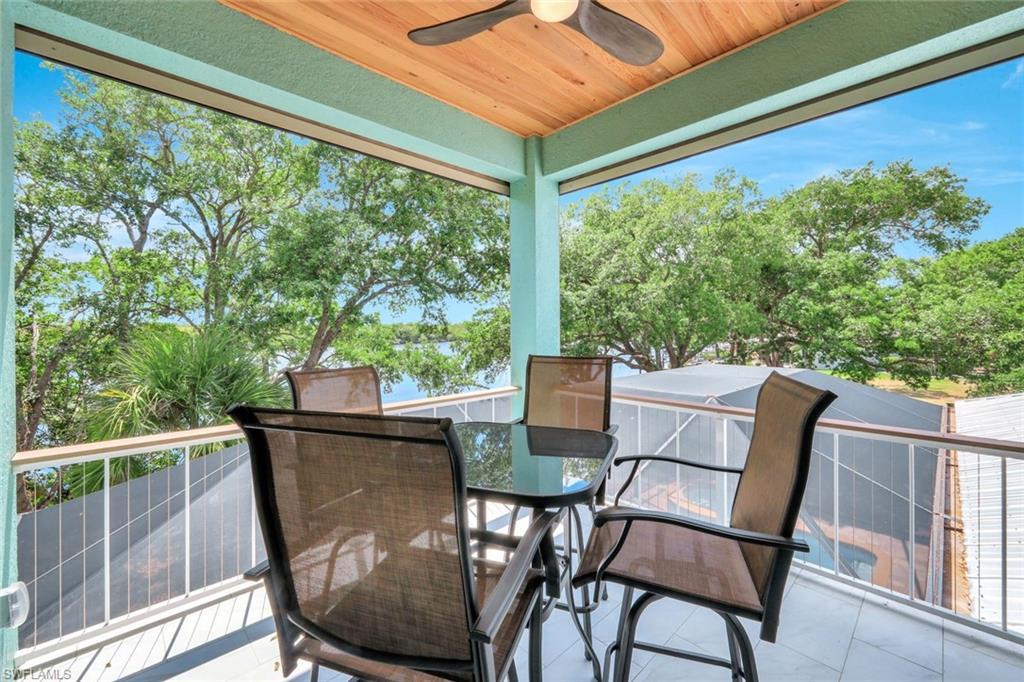 144 Wilderness Cay Naples, FL 34114 - Photo 30 of 42 a view of a chairs and table in the balcony