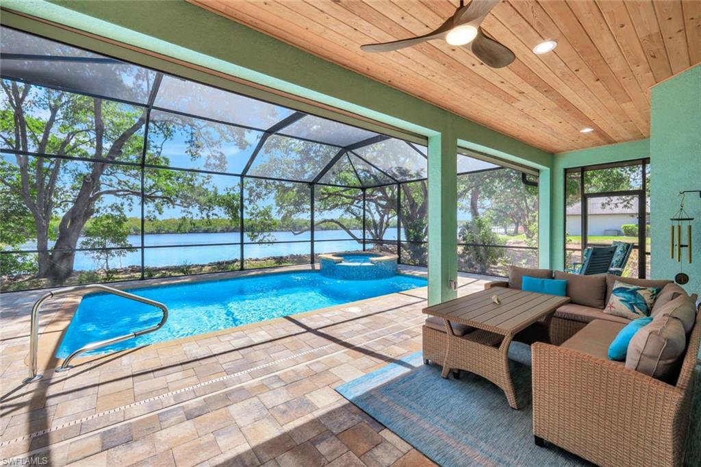 144 Wilderness Cay Naples, FL 34114 - Photo 33 of 42 a roof deck with couch and chairs