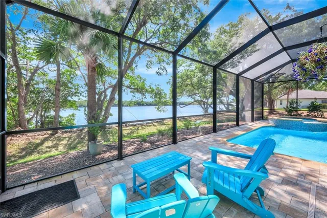 a view of backyard with a large pool and sitting area