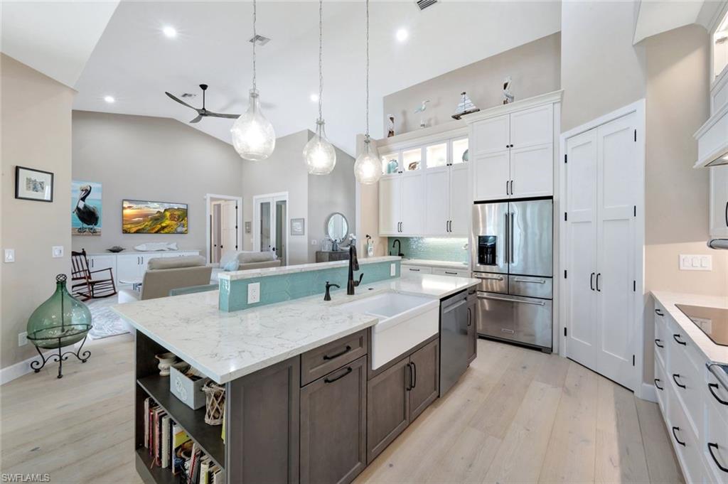 144 Wilderness Cay Naples, FL 34114 - Photo 6 of 42 a kitchen with cabinets and stainless steel appliances