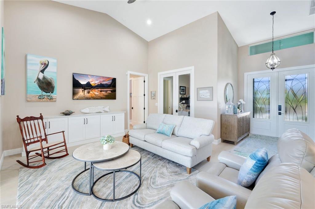 144 Wilderness Cay Naples, FL 34114 - Photo 7 of 42 a living room with furniture and a table