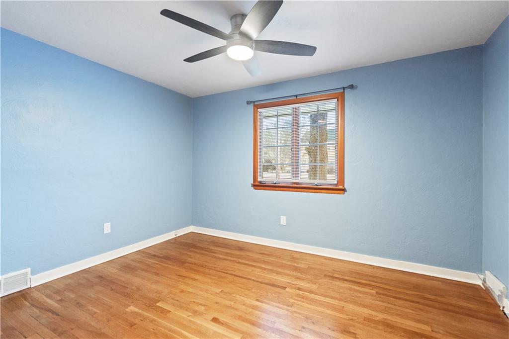 903 Wible Run Road Pittsburgh, PA 15209 - Photo 15 of 33 a view of an empty room with wooden floor and a window