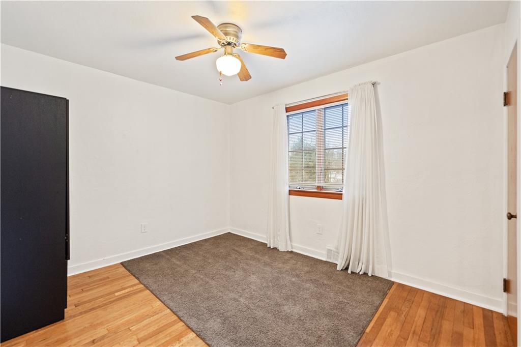 903 Wible Run Road Pittsburgh, PA 15209 - Photo 17 of 33 an empty room with a window and ceiling fan