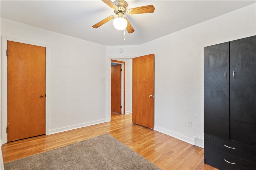 903 Wible Run Road Pittsburgh, PA 15209 - Photo 18 of 33 a view of an empty room with window and wooden floor