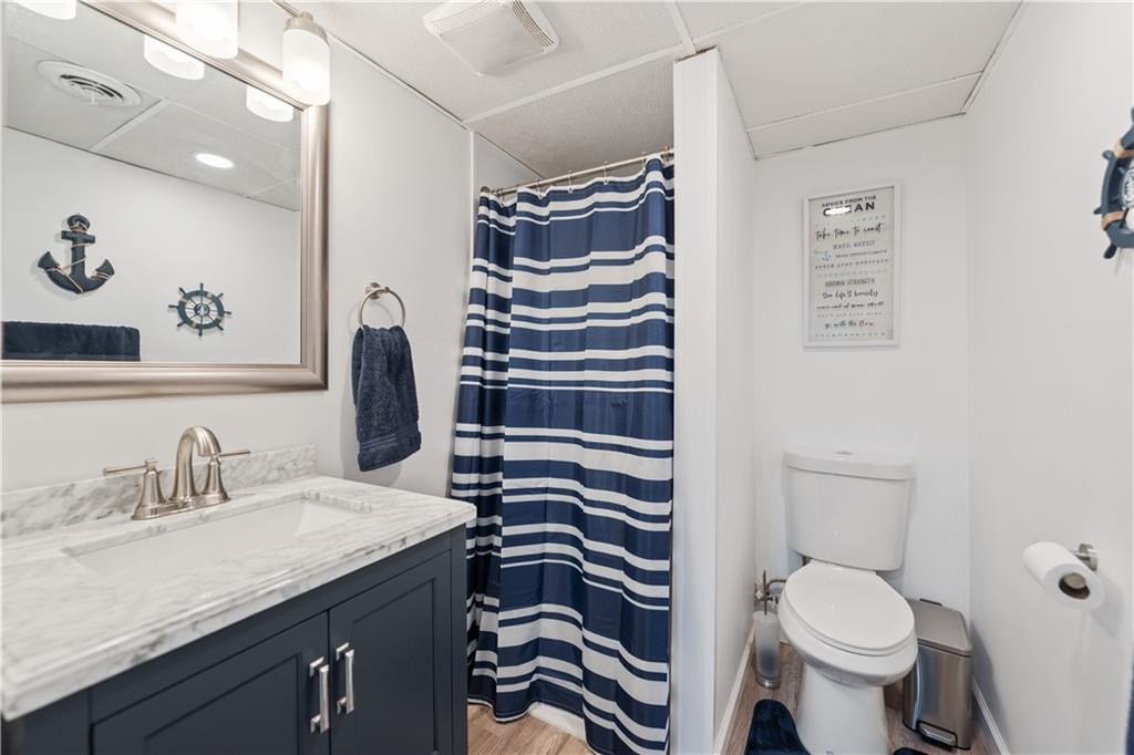 903 Wible Run Road Pittsburgh, PA 15209 - Photo 26 of 33 a bathroom with a sink a toilet and a mirror