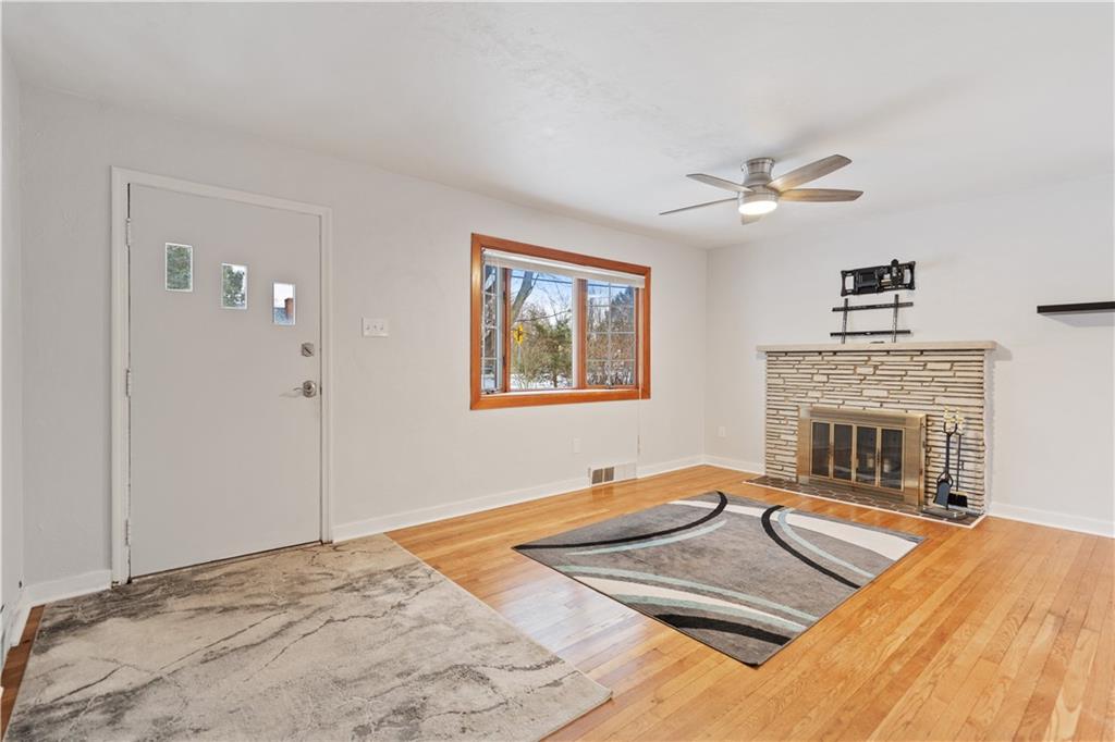 903 Wible Run Road Pittsburgh, PA 15209 - Photo 7 of 33 a living room with stainless steel appliances furniture a fireplace and a chandelier