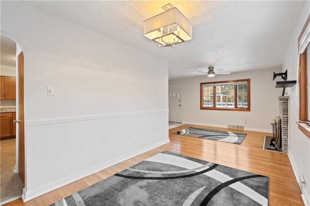 903 Wible Run Road Pittsburgh, PA 15209 - Photo 8 of 33 wooden floor in a hall with a dining table and chairs