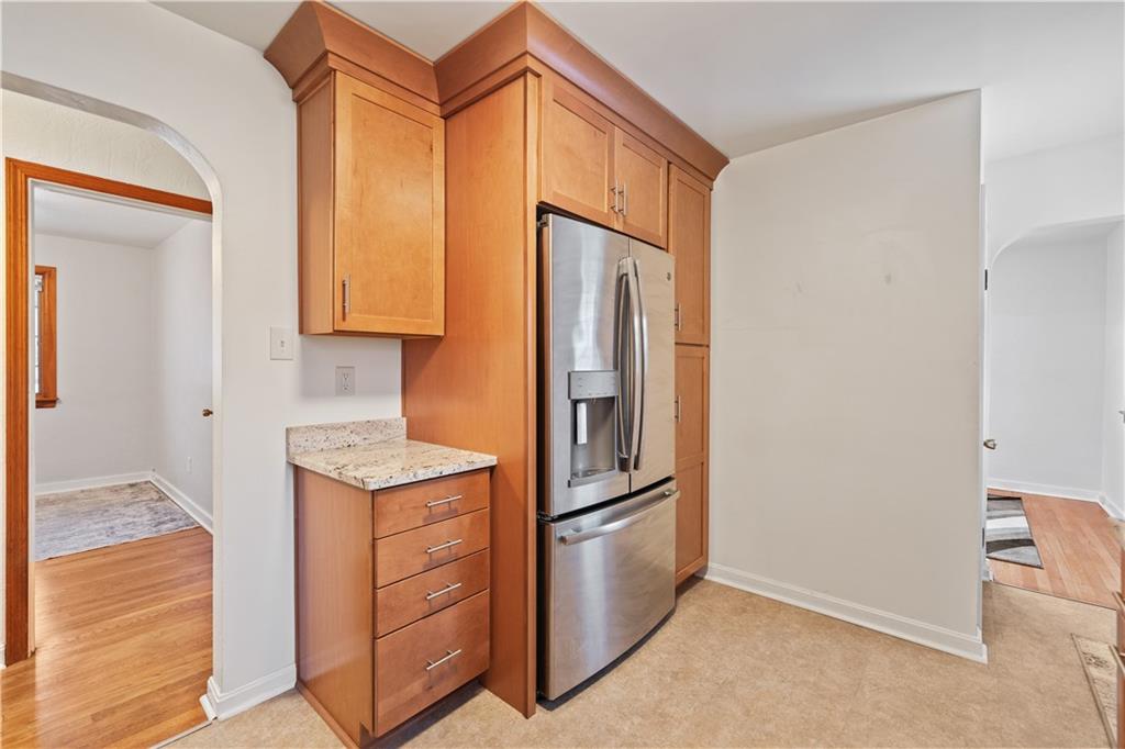 903 Wible Run Road Pittsburgh, PA 15209 - Photo 10 of 33 a kitchen with stainless steel appliances granite countertop a refrigerator and a stove