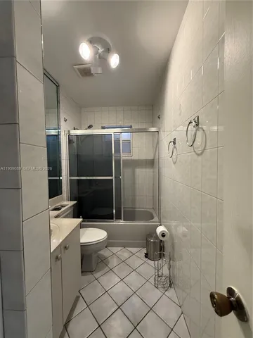 a bathroom with a toilet a sink and shower