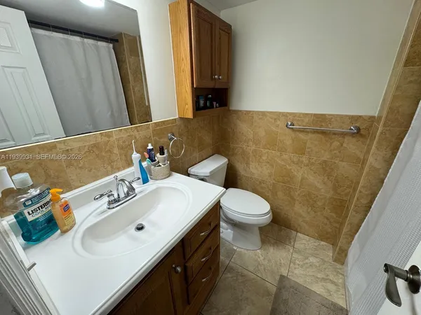 a bathroom with a sink a toilet and mirror