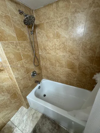 a bathroom with a bathtub and shower