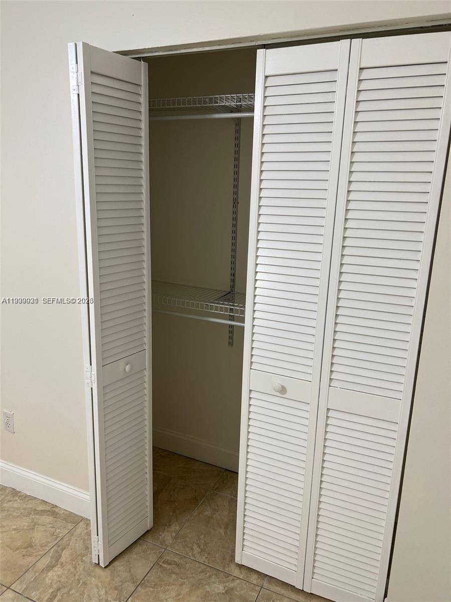 18210 Mediterranean Boulevard, Unit 620 Hialeah, FL 33015 - Photo 14 of 27 a view of a closet in an empty room