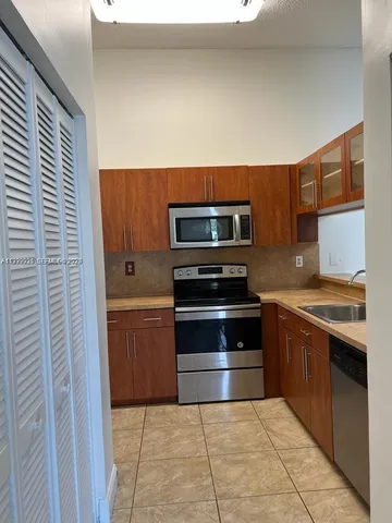 a kitchen with a stove and a microwave