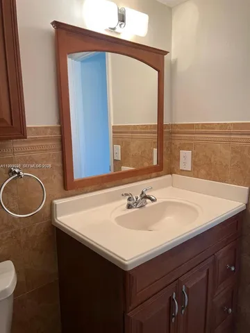 a bathroom with a sink vanity and a mirror