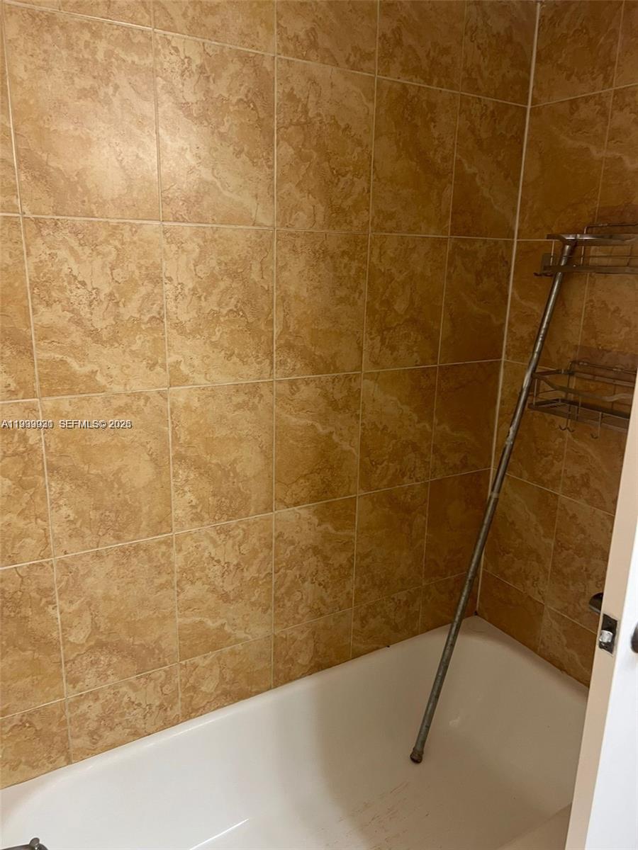18210 Mediterranean Boulevard, Unit 620 Hialeah, FL 33015 - Photo 10 of 27 a bathroom with a shower